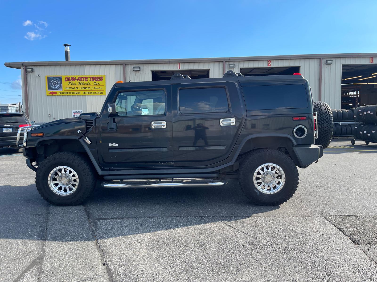 Black Hummer H2 with chrome off-road wheels