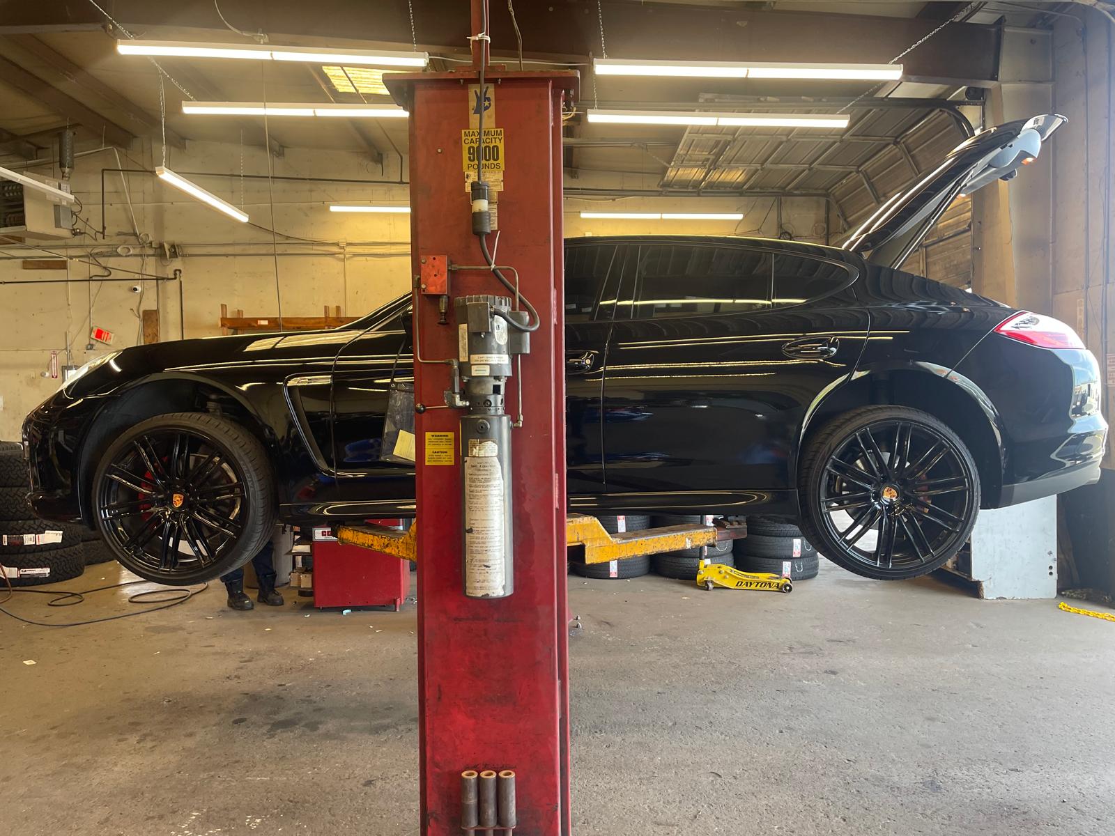 Red Jeep Wrangler getting new wheels in shop