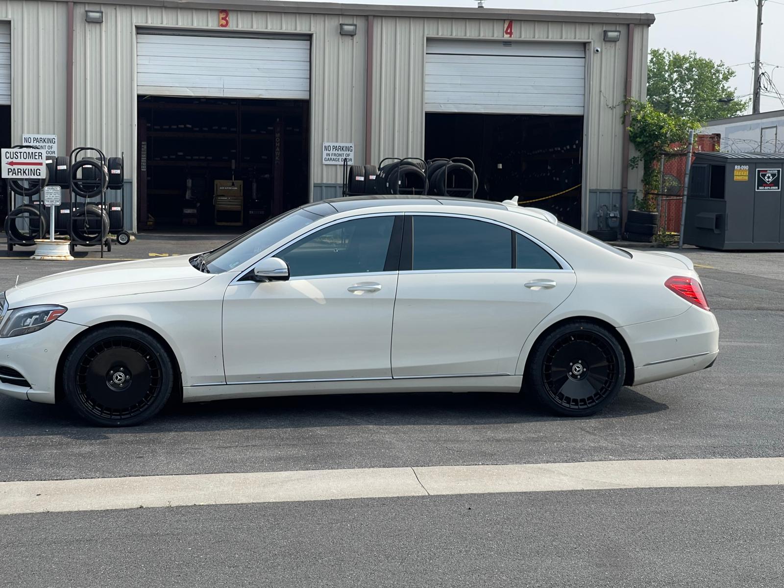 White Mercedes S-Class with custom black wheels