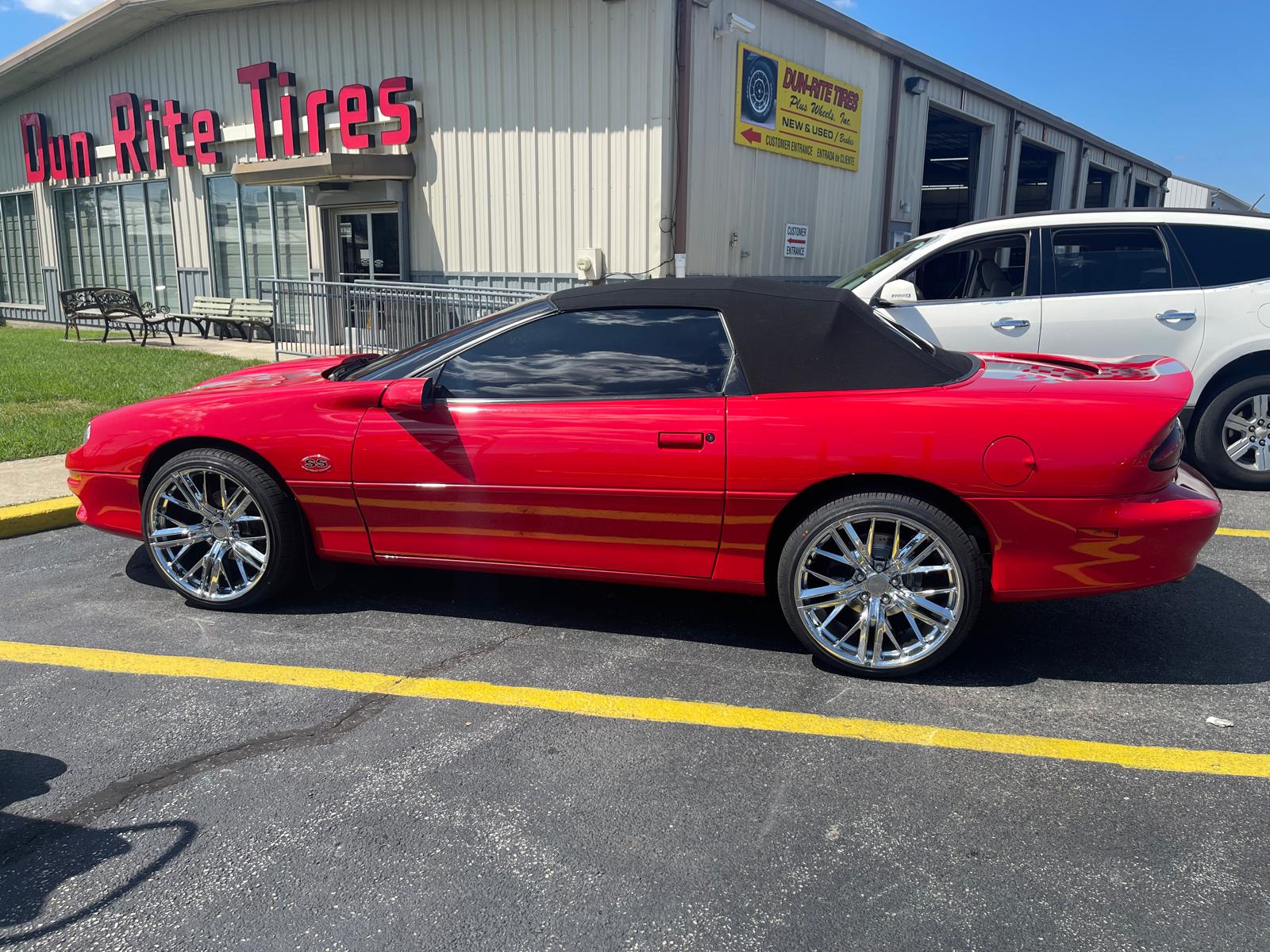 Red Camaro convertible with chrome wheels at Dun-Rite
