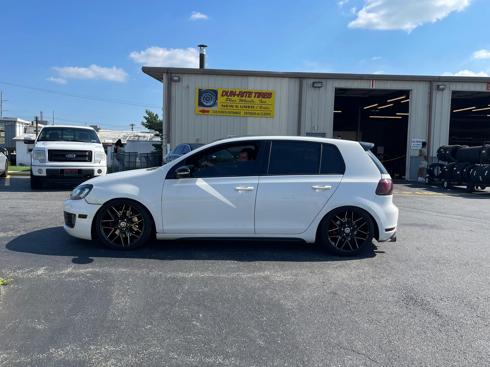 White Volkswagen Golf GTI with black wheels