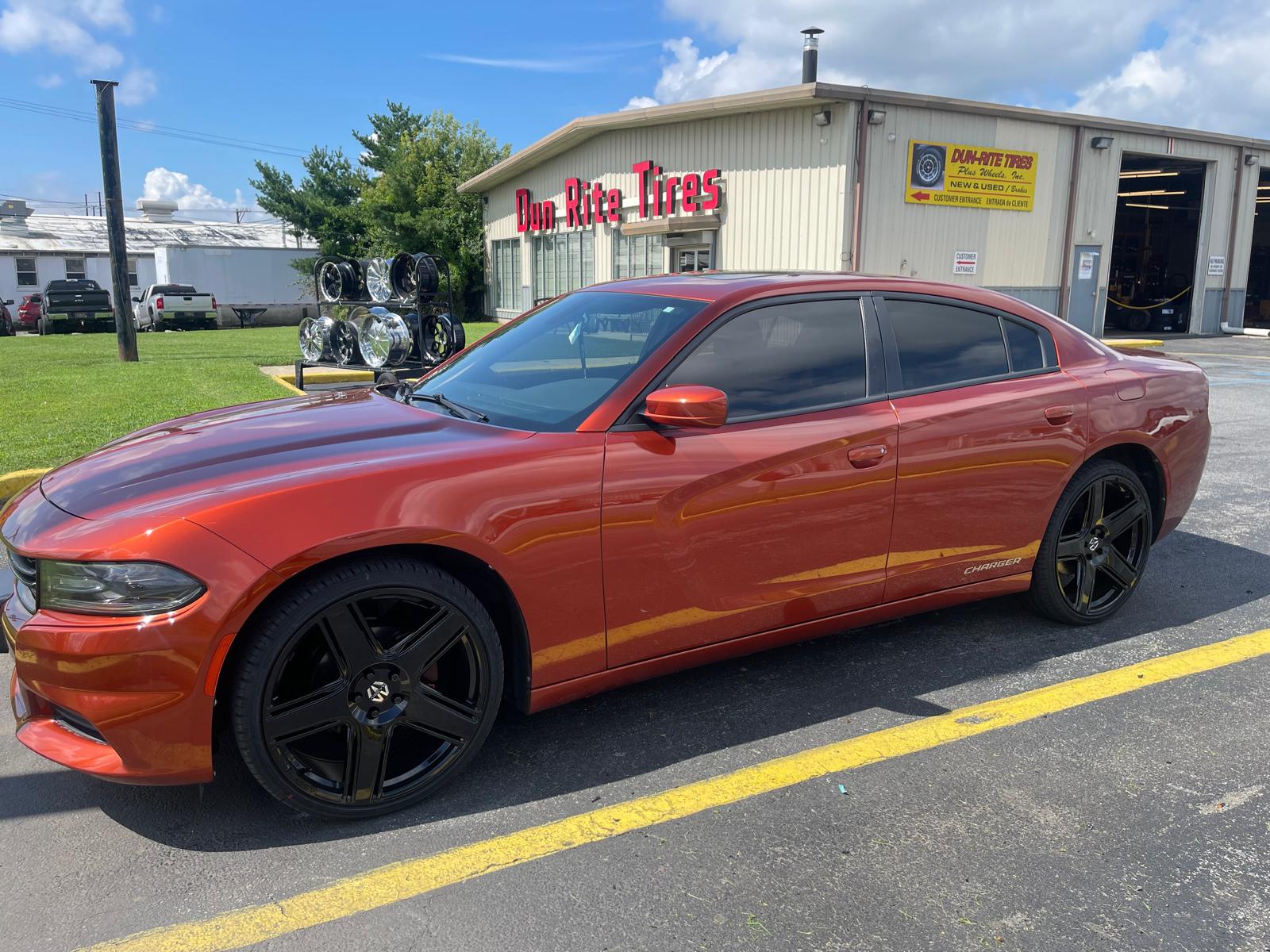 Orange Dodge Charger with custom wheels at Dun-Rite