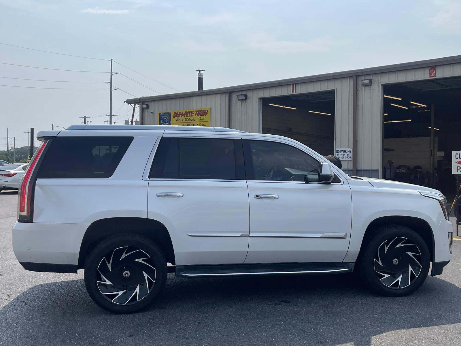 White Cadillac Escalade with custom wheels